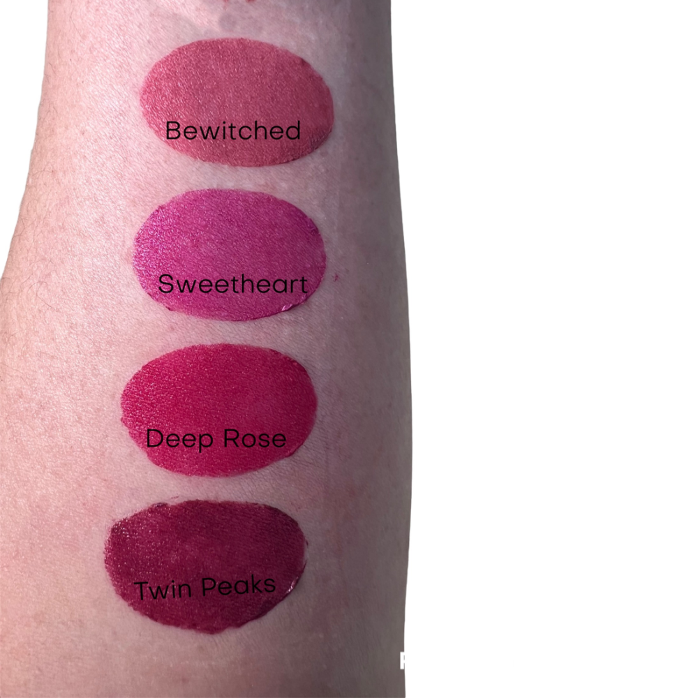 Dark pink lipstick swatch on arm